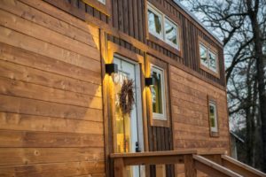 This elegant tiny house is clad in hand-made Shou Sugi Ban cedar siding.