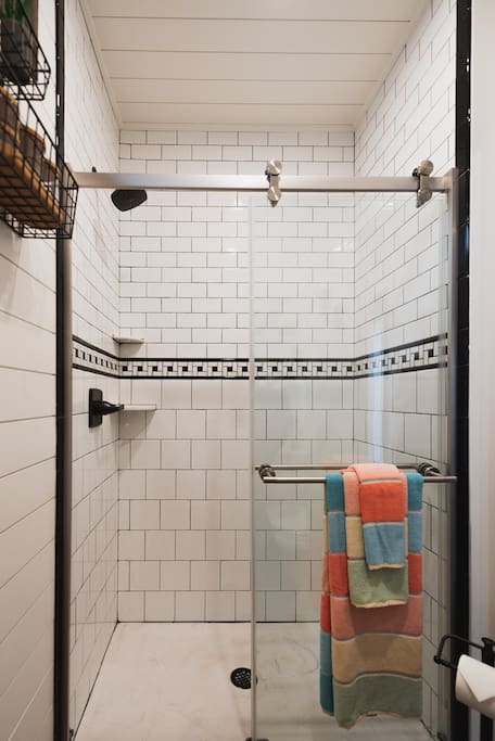 Full size, custom-tiled shower.