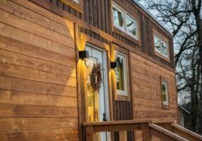 This elegant tiny house is clad in hand-made Shou Sugi Ban cedar siding.